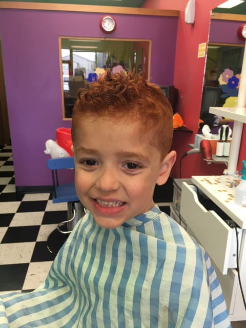 A kid with a shorter orange brown hair