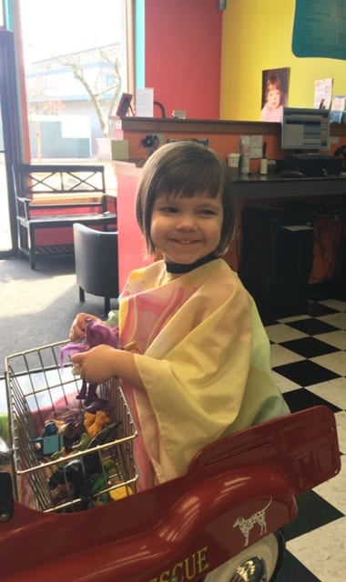 A happy kid playing with toys in the salon